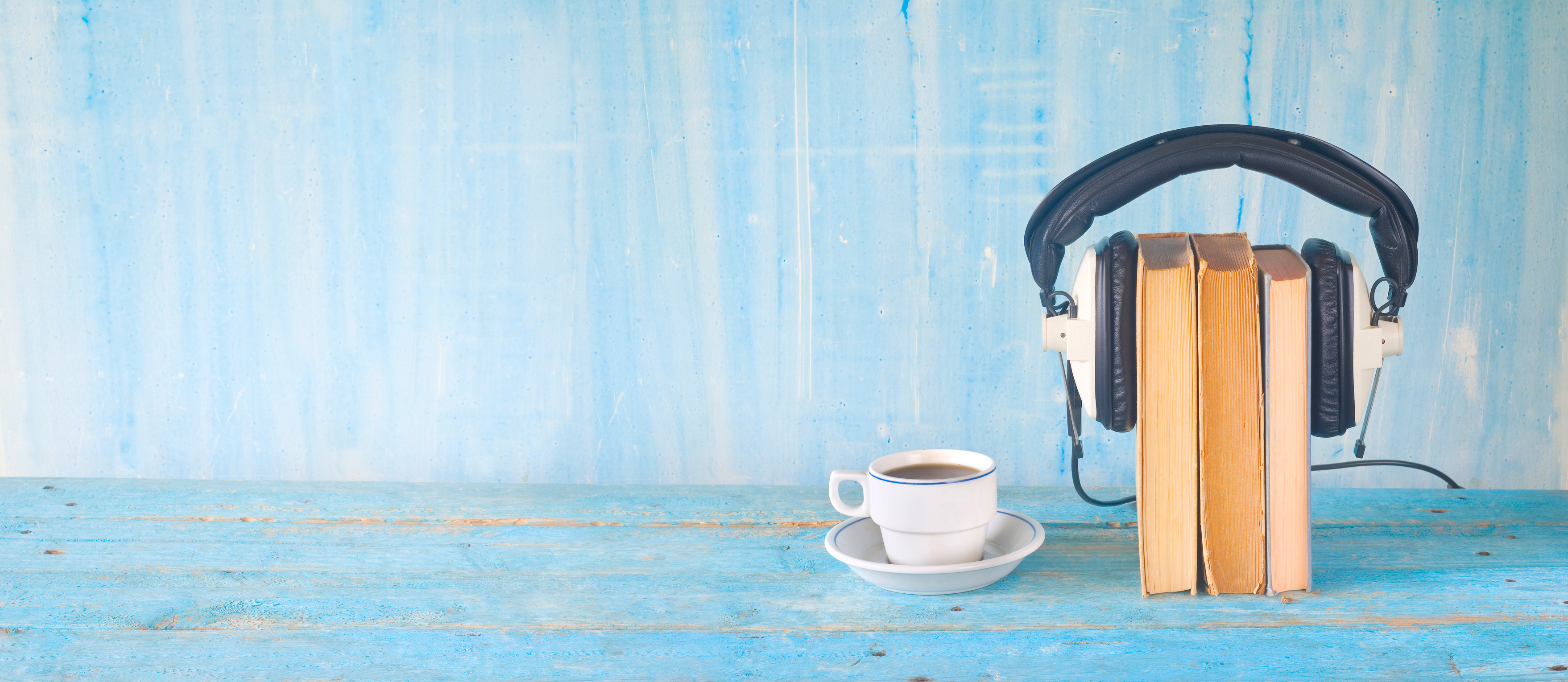 audio book concept, with book, headphones and coffee